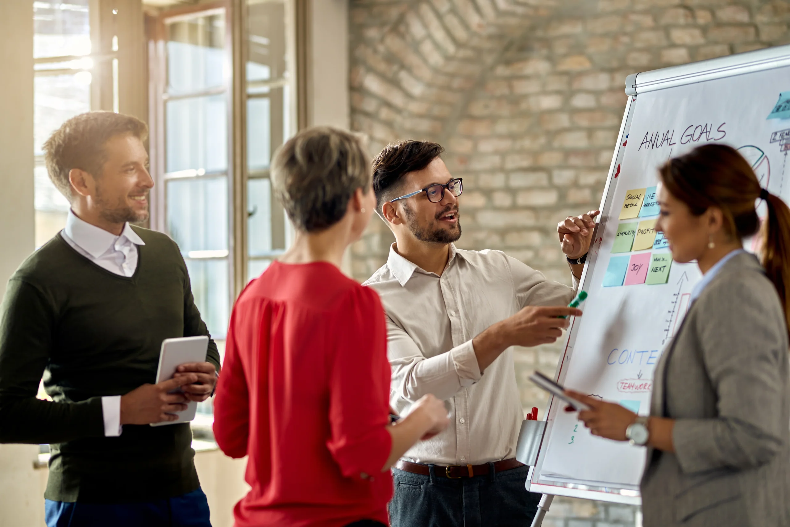 Business Team Cooperating While Developing New Business Strategy Office Focus Is Young Man Presenting Ideas Whiteboard